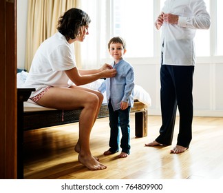 Mother Helping Son To Get Dressed