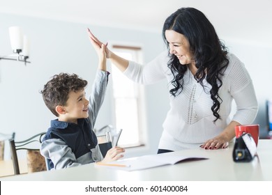 A Mother Helping Son for the Homework at home