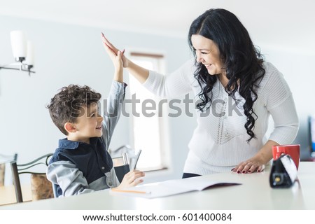 A Mother Helping Son for the Homework at home