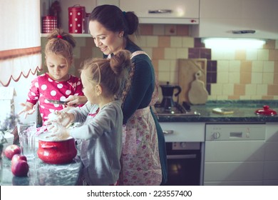 Mother With Her 5 Years Old Kids Cooking Holiday Pie In The Kitchen To Mothers Day, Casual Lifestyle Photo Series In Real Life Interior