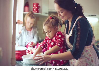 Mother With Her 5 Years Old Kids Cooking Holiday Pie In The Kitchen, Casual Lifestyle Photo Series In Real Life Interior