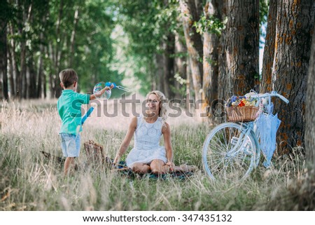 mother with her baby and a bike ride in nature