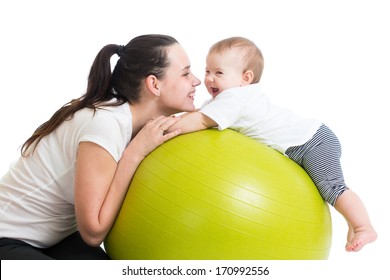 mother and her baby having fun with gymnastic ball
