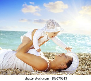 mother with her baby on the beach - Powered by Shutterstock