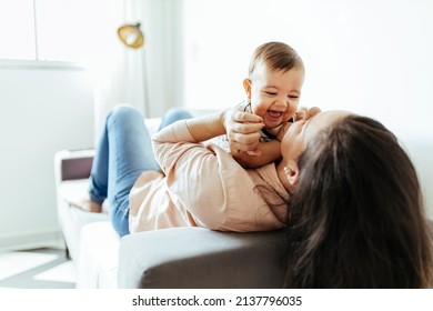 Mother And Her Baby Son Playing At Home