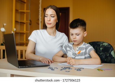 A Mother And Her Child Are Engaged In Distance Learning At Home In Front Of The Computer. Stay At Home, Training