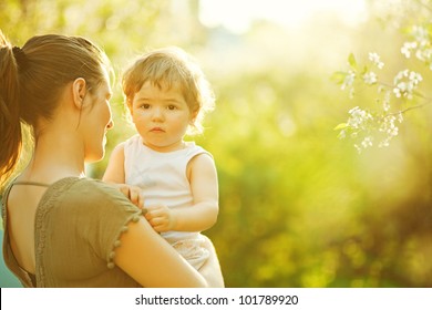 Mother And Her Child Enjoy The Early Spring