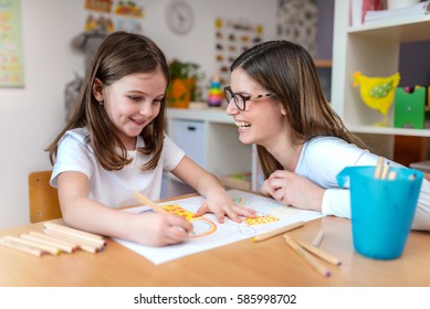 Mother with her child having creative and fun time drawing