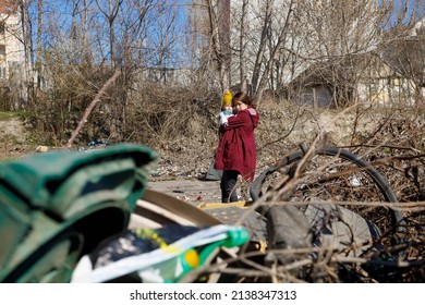 A Mother And Her Child Looking At The Devastated Ruins