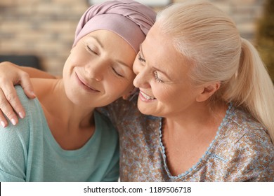 Mother with her daughter after chemotherapy at home