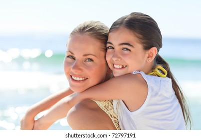 Mother With Her Daughter At The Beach