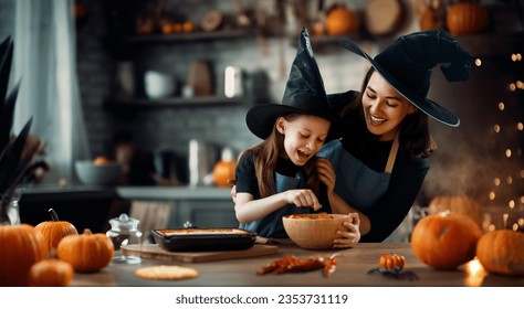 Mother and her daughter having fun at home. Happy Family preparing for Halloween. Mum and child cooking festive fare in the kitchen. - Shutterstock ID 2353731119
