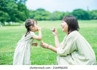 mother and her daughter playing with soap bubbles - Powered by Shutterstock