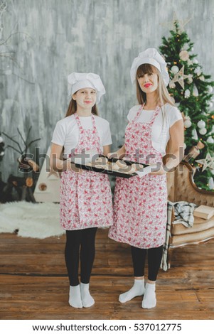 Mother with her daughter are preparing the buns