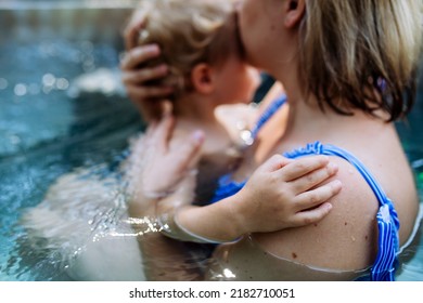 Mother With Her Little Daughter Enjoying Bathing In Wooden Barrel Hot Tub, Summer Vacation Concept.