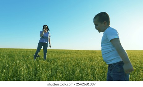 Mother With Her Little Son. Adorable Infant Baby Playing Outdoors. Happy Kid Playing Ball In Park. Mother And Son Soccer Players In Dynamic Action Funny Play. Gimbal shot. - Powered by Shutterstock