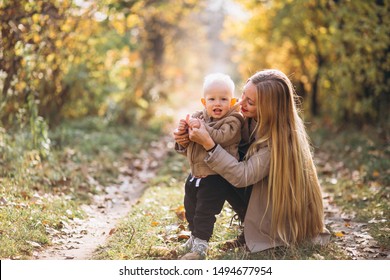 Mother with her little son in autumn park
