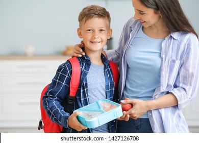 Mother And Her Little Son With Lunch Box Before School