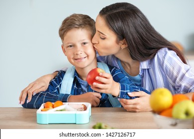 Mother And Her Little Son With Lunch Box Before School