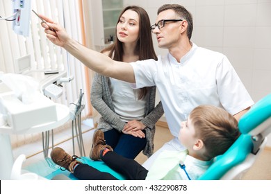 Mother and her little son on consultation of dentist in dental clinic