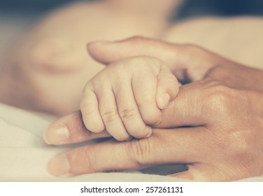 Mother With Her Newborn Baby Care Hands