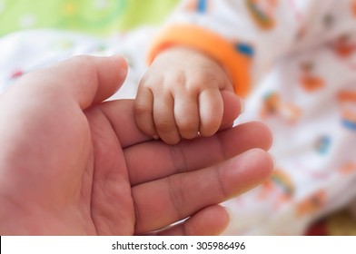 Mother With Her Newborn Baby Care Hands