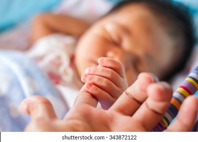 Mother With Her Newborn Baby Care Hands