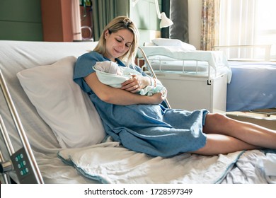 A Mother with her newborn baby at the hospital a day after a natural birth labor