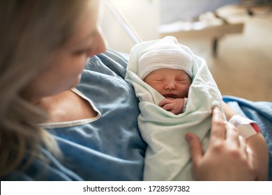 A Mother with her newborn baby at the hospital a day after a natural birth labor - Shutterstock ID 1728597382