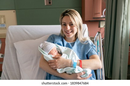 Mother With Her Newborn Baby At The Hospital A Day After A Natural Birth Labor