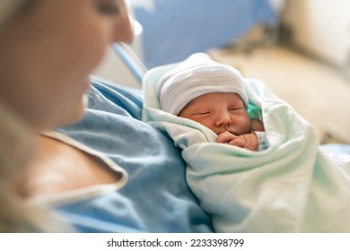 A Mother with her newborn baby at the hospital a day after a natural birth labor - Shutterstock ID 2233398799