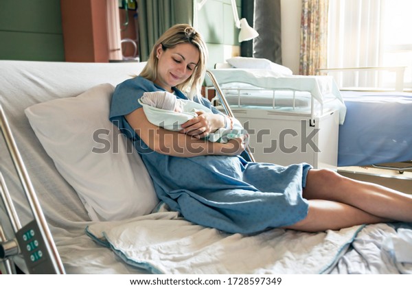 A Mother with her newborn baby at the\
hospital a day after a natural birth\
labor