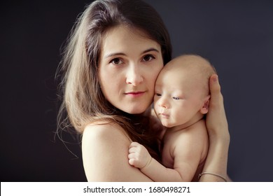 Mother And Her Newborn Baby. Studio Shoot Of Mother And Infant. 