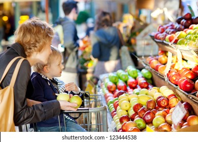 mother and her son buying fruits at a farmers market - Powered by Shutterstock