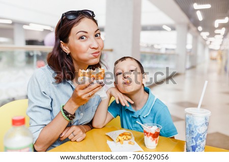 Mother And her son Having a fast food Lunch Together At The Mall