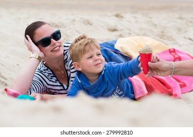 mother with her son on the beach getting an ice-cream - Powered by Shutterstock