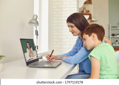 Mother And Her Son Participating In Online Class At Home. Parent And Child Talking To Teacher On Web. Distance Learning