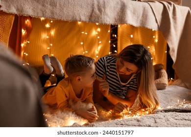 Mother and her son in play tent at home - Powered by Shutterstock