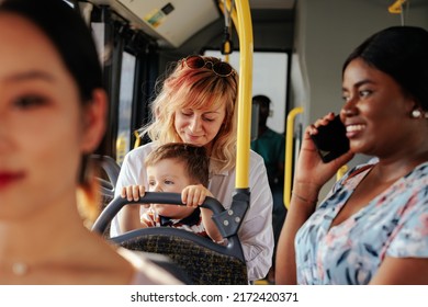 The mother and her son are using public transportation. By their side standing african american woman and talking on the phone - Powered by Shutterstock