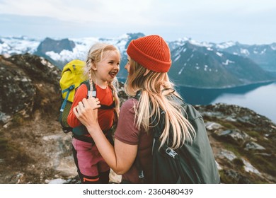 Mother hiking with daughter in Norway mountains travel together family time healthy lifestyle active vacations woman playing with child Mother's day holiday - Powered by Shutterstock