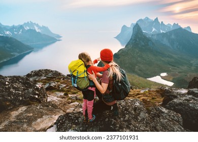 Mother hiking with kid daughter family travel hobby active vacations outdoor in Norway healthy lifestyle in mountains woman with child enjoying views of Senja island Mother's day holiday - Powered by Shutterstock