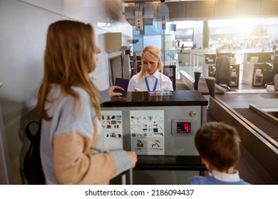 Mother And His Son At Airport Checkin Desk Leaving On Trip