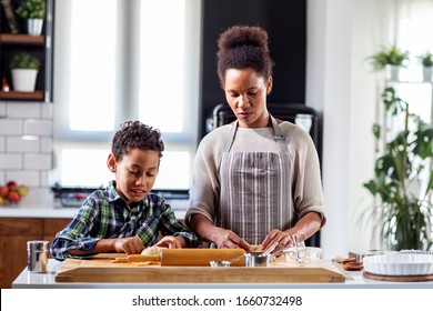 Mother with his son prepare pie in the kitchen - Shutterstock ID 1660732498