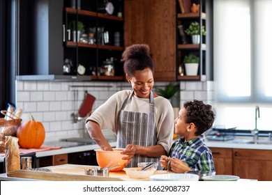 Mother with his son prepare pie in the kitchen