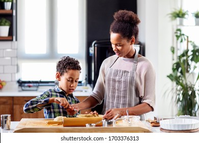 Mother with his son prepare pie in the kitchen - Shutterstock ID 1703376313