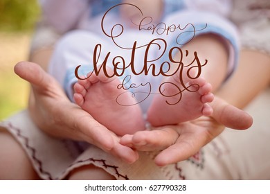 Mother hold the feet of her newborn son and Happy mothers day text. Calligraphy lettering hand draw