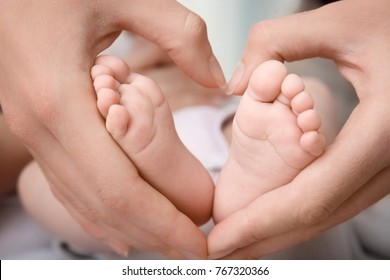 Mother Holding Baby Feet, Closeup