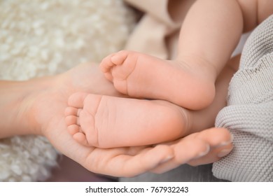 Mother Holding Baby Feet, Closeup