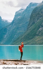 Mother Holding Up Baby Traveling Together Enjoying Lovatnet Lake And Mountains View Family Lifestyle Mom And Child Active Family Vacation Healthy Lifestyle Outdoors Mothers Day