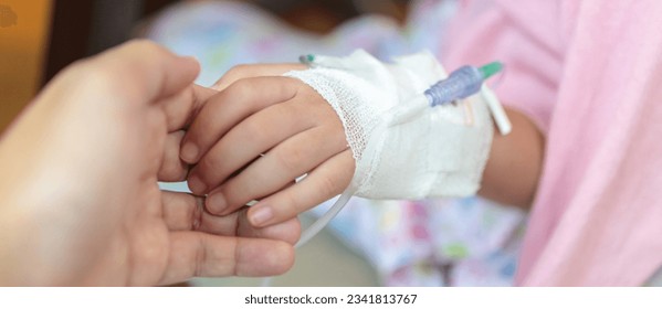 Mother holding child hand with saline IV solution in hospital - Powered by Shutterstock